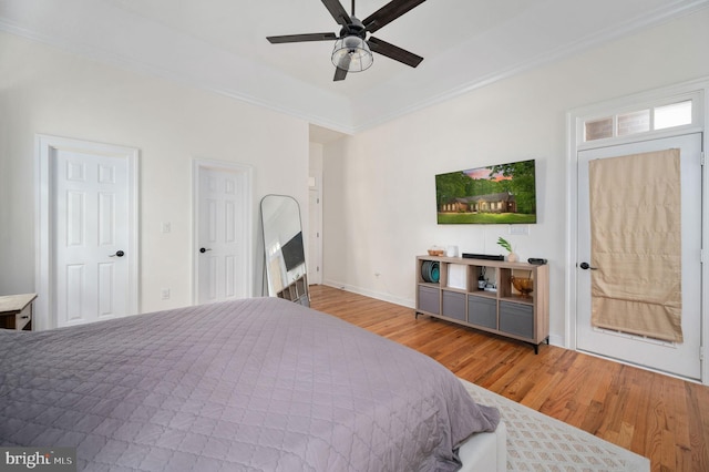 bedroom featuring baseboards, ceiling fan, ornamental molding, and wood finished floors