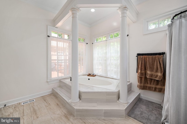 full bath featuring baseboards, decorative columns, visible vents, ornamental molding, and a bath