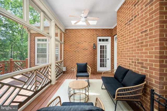 sunroom with an outdoor living space and a ceiling fan