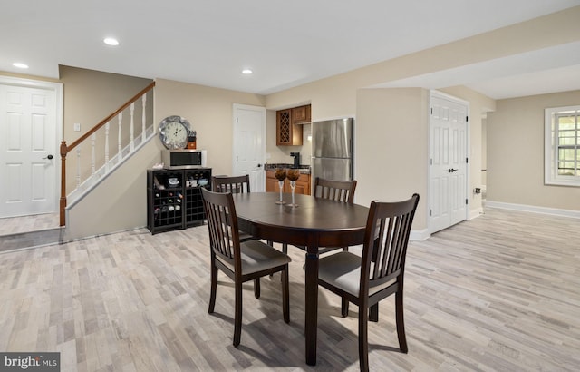 dining space with stairway, baseboards, recessed lighting, and light wood-style flooring