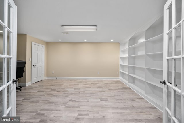 unfurnished room with baseboards, visible vents, french doors, and light wood finished floors