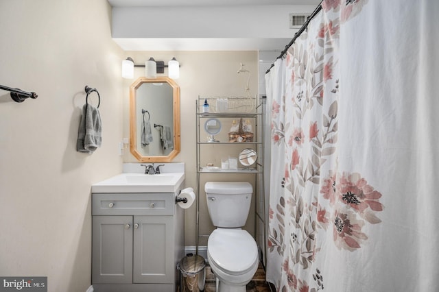 full bathroom with vanity, a shower with shower curtain, visible vents, and toilet