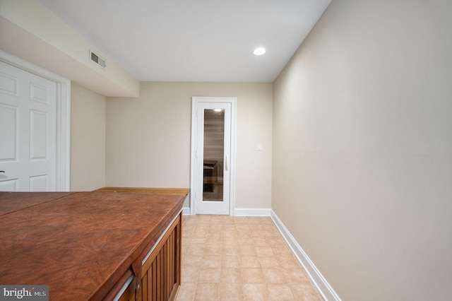 corridor featuring recessed lighting, baseboards, and visible vents