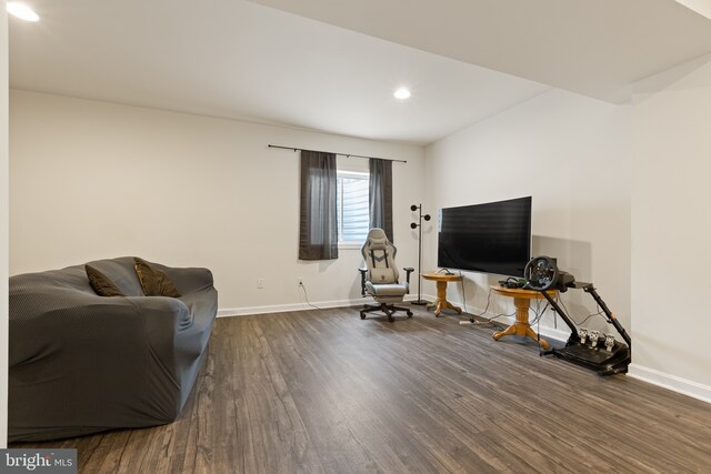 living area with recessed lighting, baseboards, and dark wood-style flooring