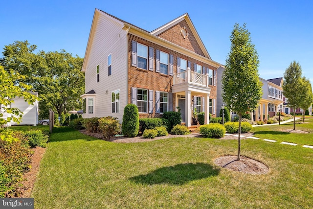 52 Primrose Hill Ln, Annapolis, MD 21403 - colonial house featuring brick siding, a front yard, and a balcony
