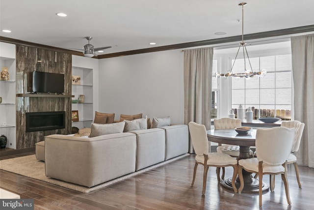 52 Primrose Hill Ln, Annapolis, MD 21403 - living area featuring ornamental molding, wood finished floors, a chandelier, a ceiling fan, and built in features