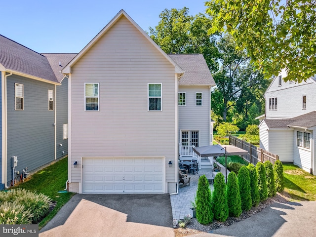 52 Primrose Hill Ln, Annapolis, MD 21403 - view of front of house with asphalt driveway, fence, and a garage