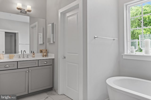 52 Primrose Hill Ln, Annapolis, MD 21403 - full bathroom featuring marble look tiles, a freestanding tub, and vanity
