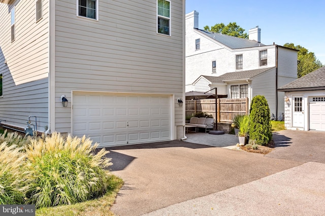 52 Primrose Hill Ln, Annapolis, MD 21403 - garage with fence and asphalt driveway