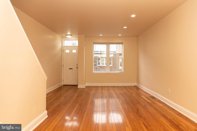 foyer entrance featuring hardwood / wood-style floors, baseboards, and recessed lighting