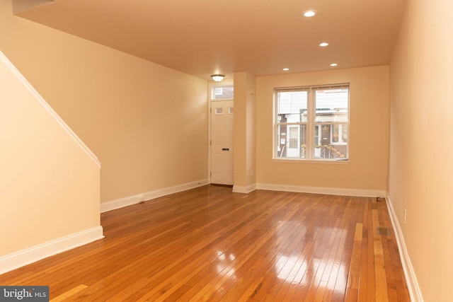 spare room with hardwood / wood-style flooring, baseboards, and recessed lighting