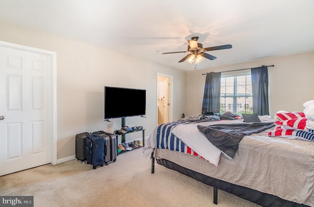 carpeted bedroom with baseboards and ceiling fan