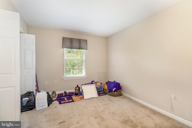 recreation room featuring carpet flooring and baseboards