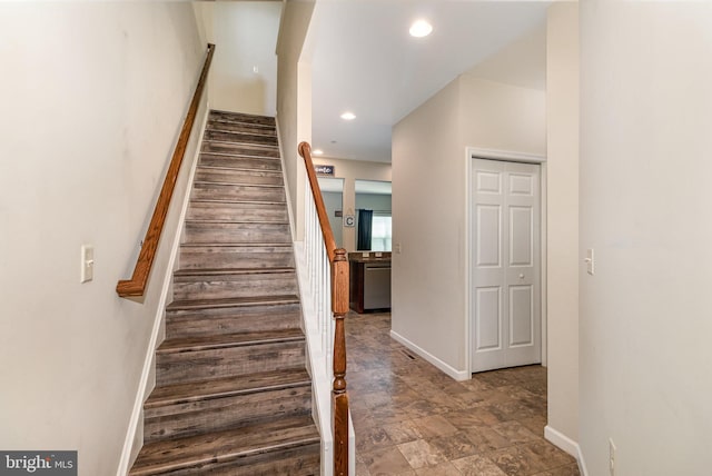 staircase featuring baseboards and recessed lighting