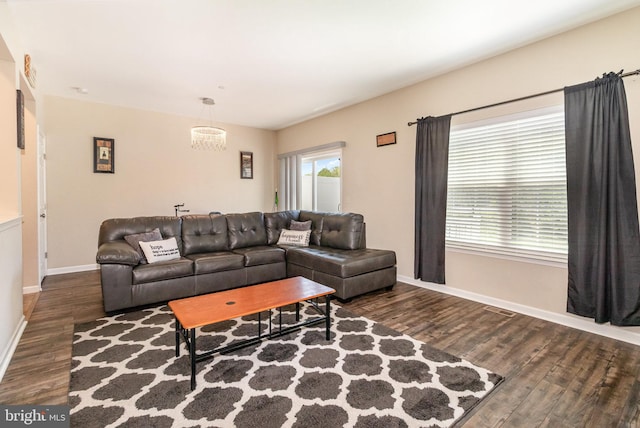 living room featuring baseboards, visible vents, and wood finished floors