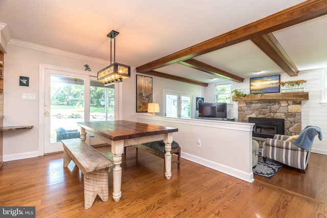 4690 Derby Ln, Doylestown, PA 18902 - dining room with wood finished floors, a stone fireplace, beam ceiling, a chandelier, and crown molding
