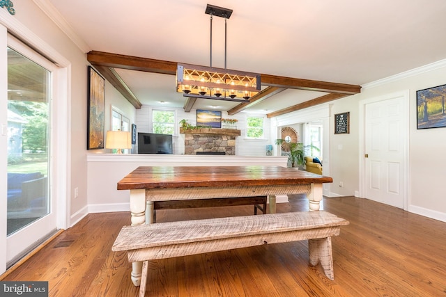4690 Derby Ln, Doylestown, PA 18902 - dining area with wood finished floors, ornamental molding, beamed ceiling, and a stone fireplace
