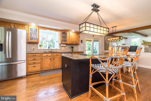 4690 Derby Ln, Doylestown, PA 18902 - kitchen featuring stainless steel fridge, light wood-type flooring, glass insert cabinets, decorative backsplash, and healthy amount of natural light