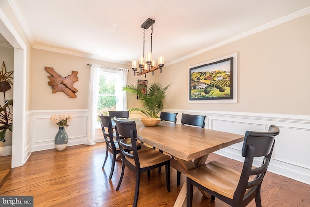 4690 Derby Ln, Doylestown, PA 18902 - dining room featuring crown molding, a chandelier, a wainscoted wall, and light wood-type flooring