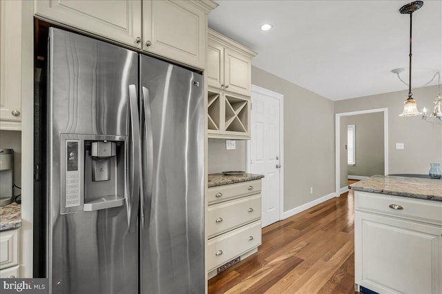 317 Nicholas, Wilmington, DE 19808 - kitchen featuring stainless steel fridge, wood finished floors, decorative light fixtures, baseboards, and cream cabinetry