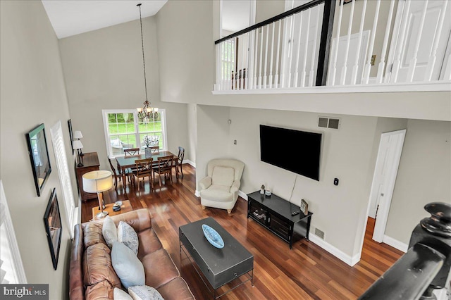 317 Nicholas, Wilmington, DE 19808 - living area featuring high vaulted ceiling, a chandelier, wood finished floors, and baseboards