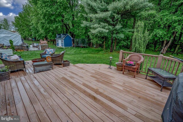 317 Nicholas, Wilmington, DE 19808 - wooden terrace featuring a storage unit, an outbuilding, a lawn, outdoor lounge area, and view of scattered trees