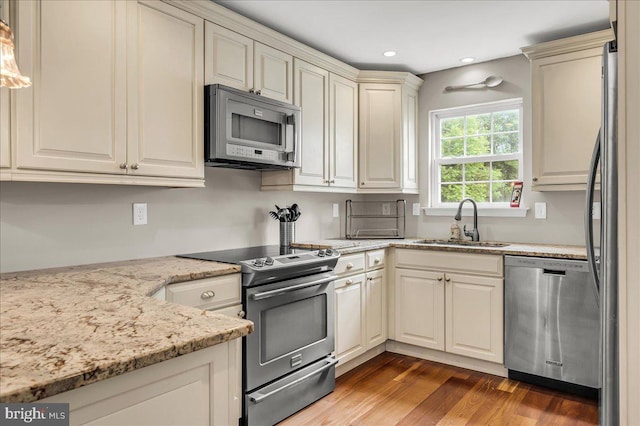 317 Nicholas, Wilmington, DE 19808 - kitchen with stainless steel appliances, a sink, light wood-style floors, light stone counters, and recessed lighting