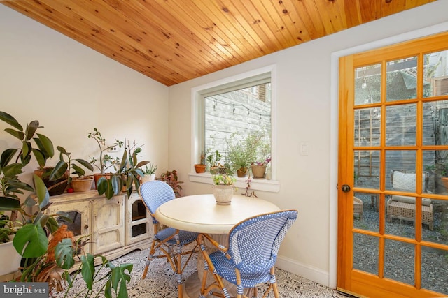 dining room with baseboards and wooden ceiling