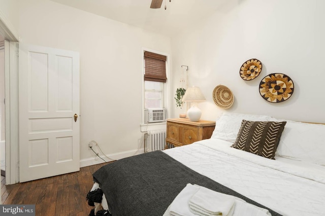 bedroom featuring a ceiling fan, dark wood-style flooring, baseboards, cooling unit, and radiator heating unit