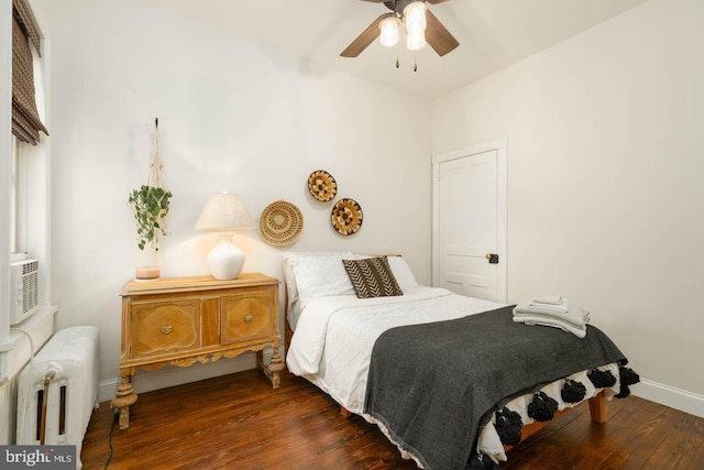 bedroom featuring baseboards, ceiling fan, radiator, and hardwood / wood-style floors