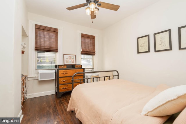 bedroom featuring baseboards, wood finished floors, and cooling unit