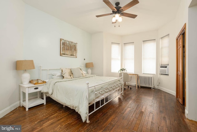 bedroom featuring radiator heating unit, baseboards, wood-type flooring, and a ceiling fan
