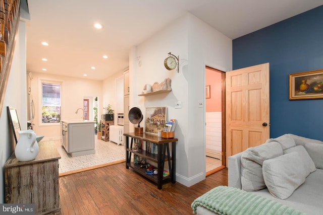 living area featuring recessed lighting, baseboards, a baseboard radiator, and dark wood-style floors
