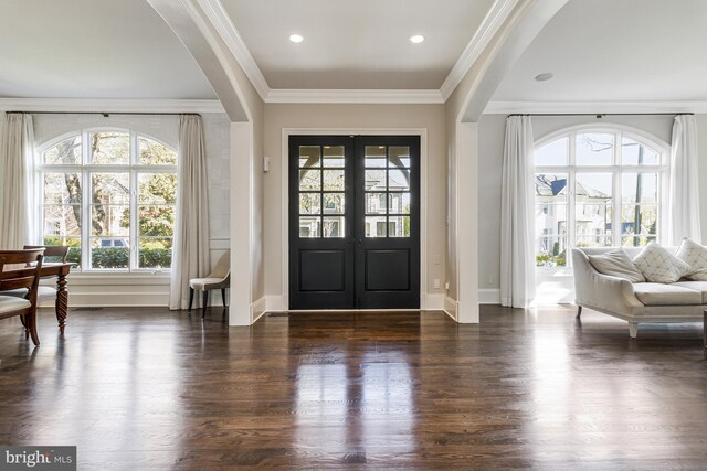entryway with crown molding, baseboards, dark wood finished floors, and french doors