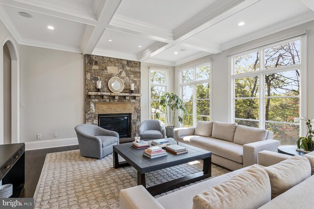 living area with ornamental molding, coffered ceiling, wood finished floors, and beamed ceiling