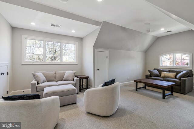 living area featuring recessed lighting, baseboards, visible vents, and lofted ceiling