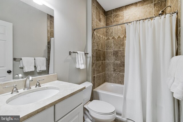 full bathroom with vanity, toilet, and shower / tub combo with curtain