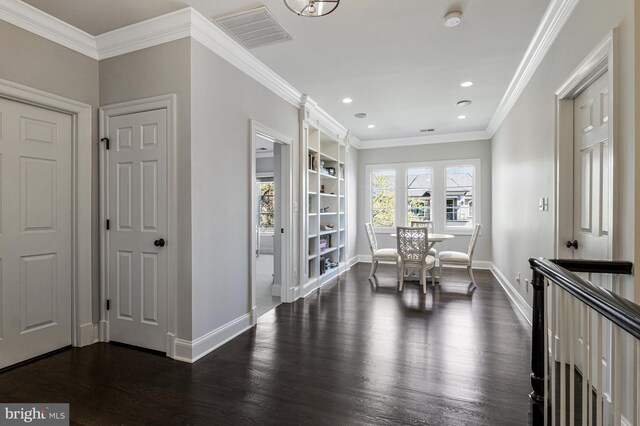 interior space featuring visible vents, ornamental molding, baseboards, recessed lighting, and dark wood-type flooring