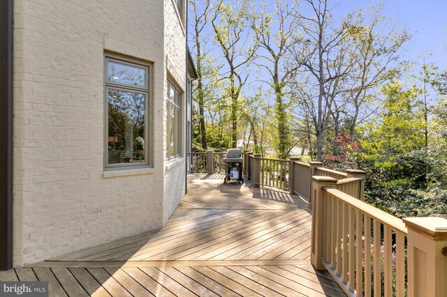 wooden terrace with a grill