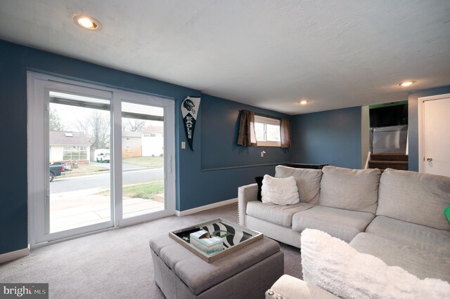 carpeted living area with baseboards, recessed lighting, and a wealth of natural light