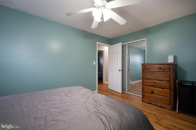 bedroom featuring baseboards, ceiling fan, and wood finished floors