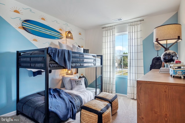 carpeted bedroom featuring baseboards and visible vents