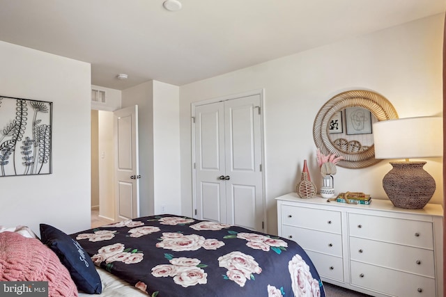 bedroom featuring visible vents and a closet