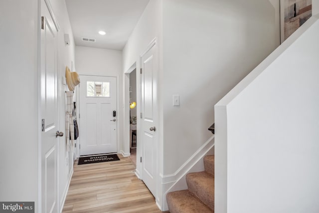 entrance foyer featuring visible vents, stairway, baseboards, light wood finished floors, and recessed lighting