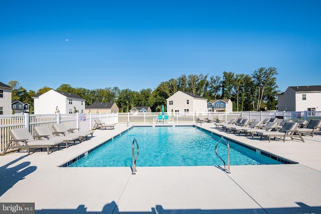 pool with fence, a residential view, and a patio area
