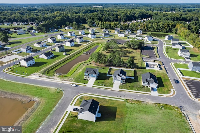 bird's eye view featuring a residential view and a wooded view