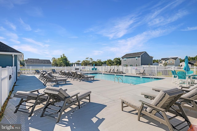 community pool featuring a patio and fence
