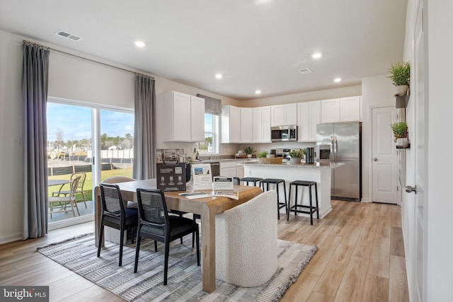 dining space with visible vents, recessed lighting, and light wood-style flooring