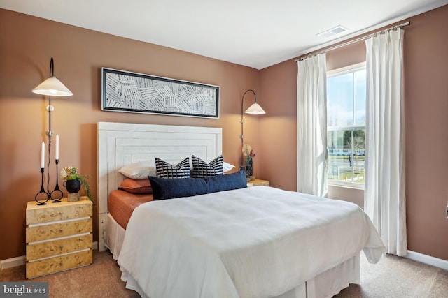 bedroom featuring baseboards, visible vents, and carpet