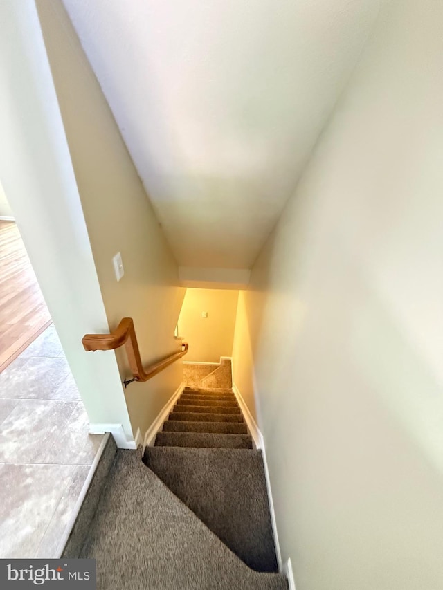 stairs with carpet flooring and baseboards